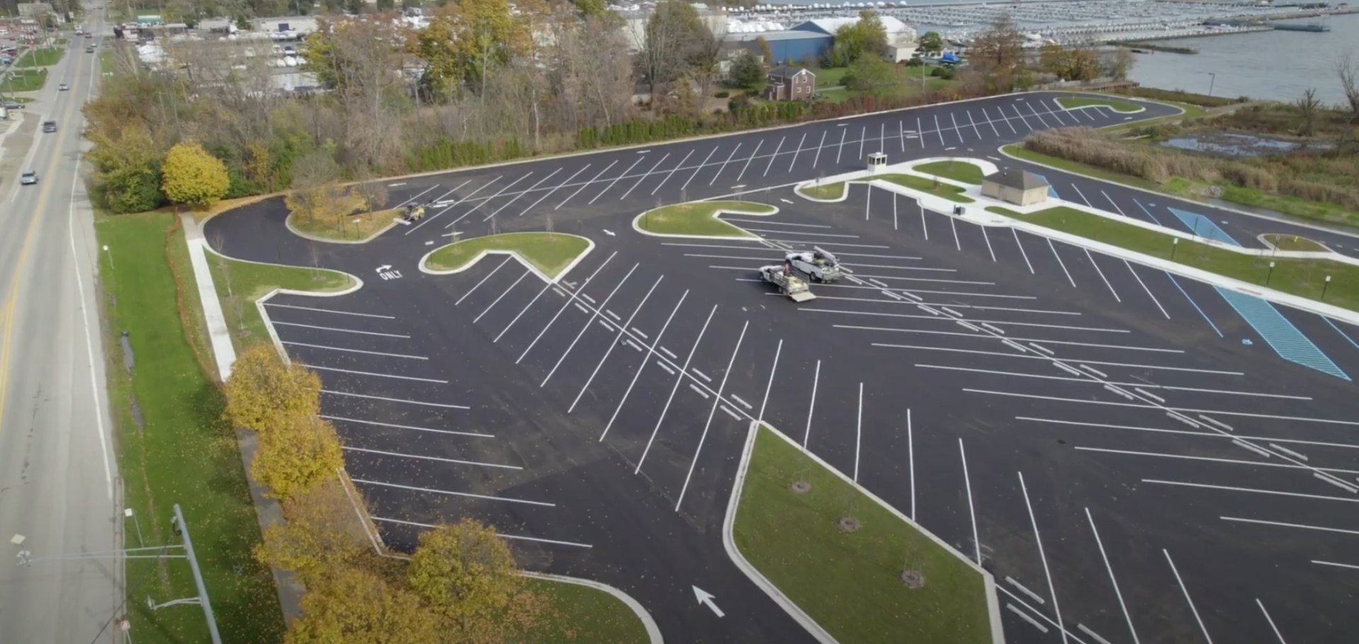 Professional Landscaping Process and Project Management Aerial view of commercial landscaping project showing organized parking lot with landscaped islands and professional design